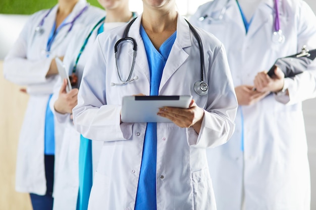 Group of doctors and nurses standing in the hospital room