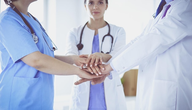 Group of doctors putting their hands together closeup