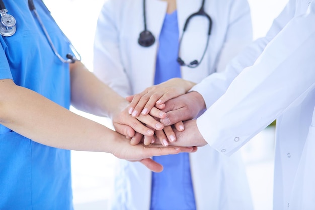 Group of doctors putting their hands together Closeup