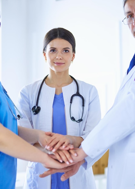 Group of doctors putting their hands together