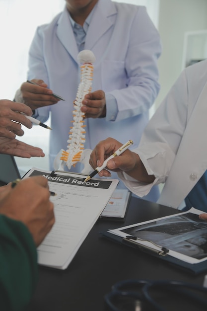 Group of doctors reading a document in meeting room at hospital