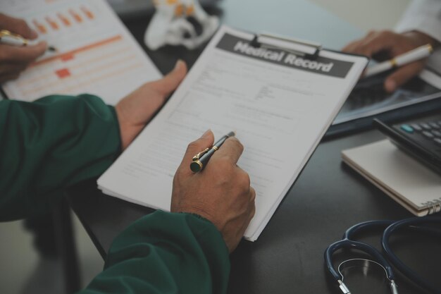 Photo group of doctors reading a document in meeting room at hospital