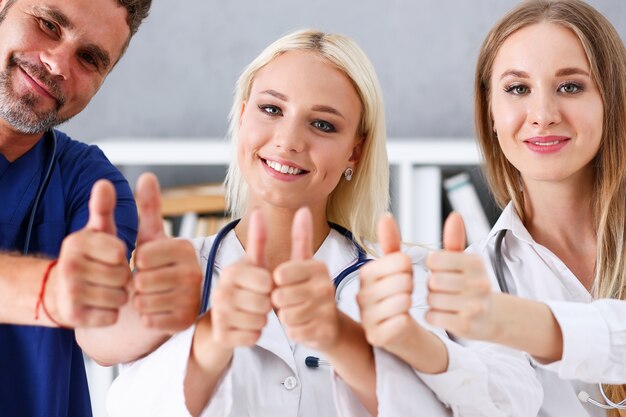 Group of doctors show the thumbs up sign