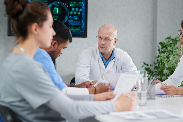 Group of doctors sitting at meeting