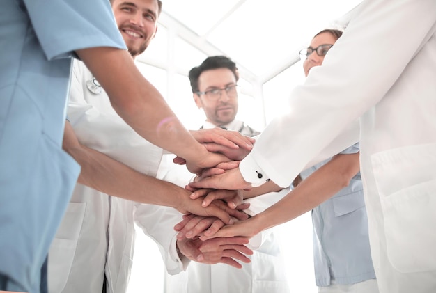 Group of doctors with their hands folded together