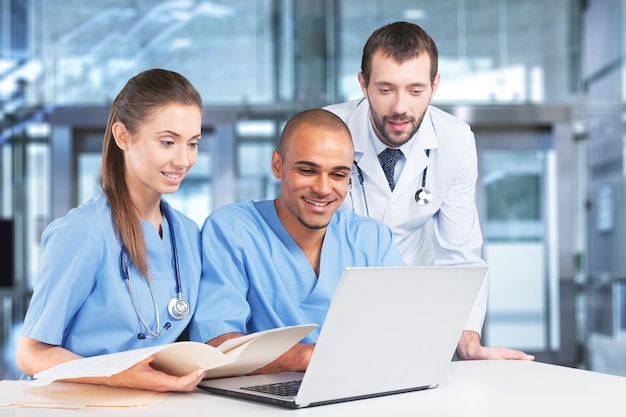 Group doctors working on laptop