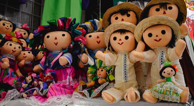 A group of dolls are sitting on a table