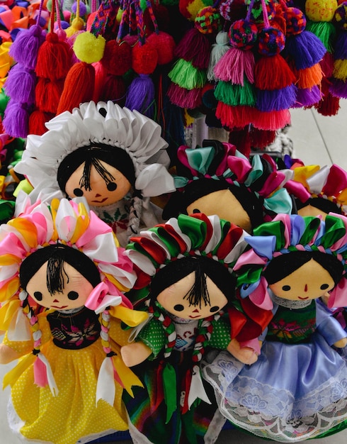 A group of dolls with colorful pom poms on them