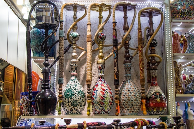 Group of eastern hookahs of various colors on a shelf