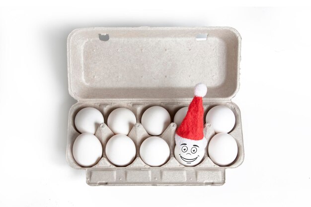 Group of eggs in toy christmas hats with drawn emotions