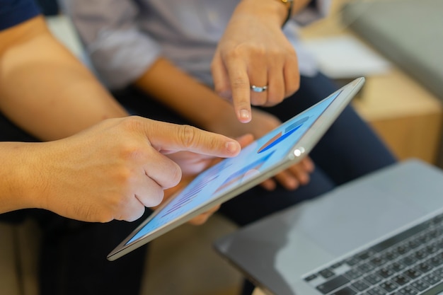 Group of employee point on tablet pad display for consult stock statistic