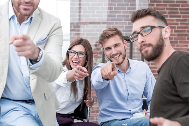 Group of employees pointing their fingers at you