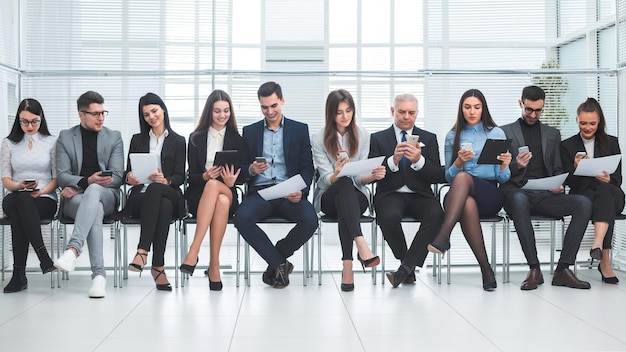 Group of employees using their devices in the conference room. photo with a copy of the space