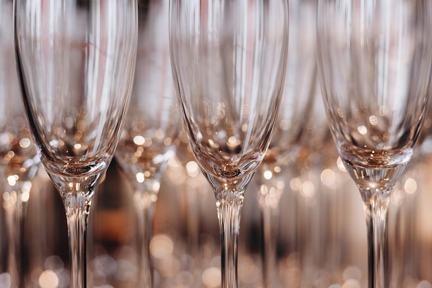 Group of empty and transparent champagne glasses in a restaurant Clean glasses on a table prepared by the bartender for champagne Catering for the event preparation empty glasses for drink