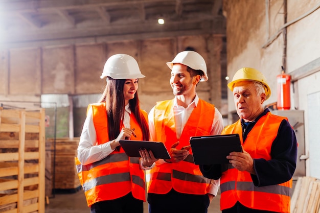 Group of engineers and workers discuss production plans