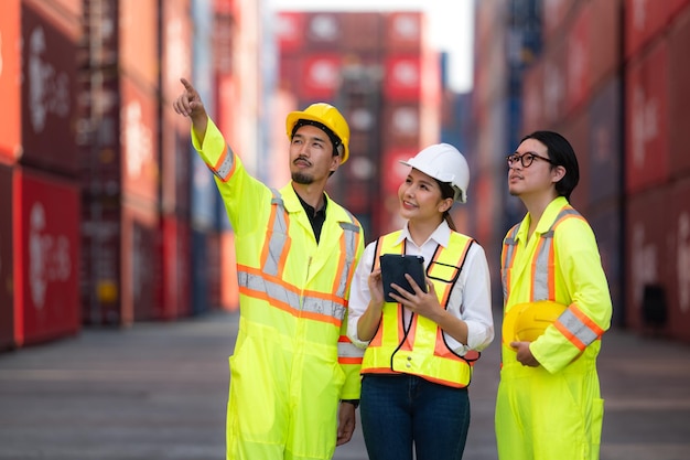 Group of engineers working with laptop in the container yard