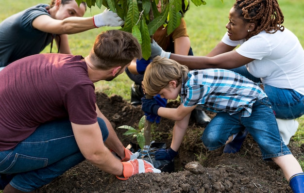 Group of environmental conservation people planting together