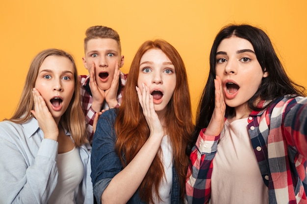 Group of excited school friends taking a selfie