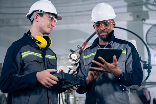 Group of factory job workers using adept machine equipment in a workshop