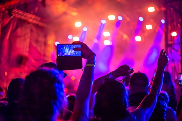 A group of fans raised their hands up at a music concert