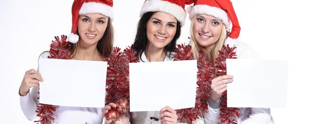 Group of female students in costumes of Santa Claus holding bla