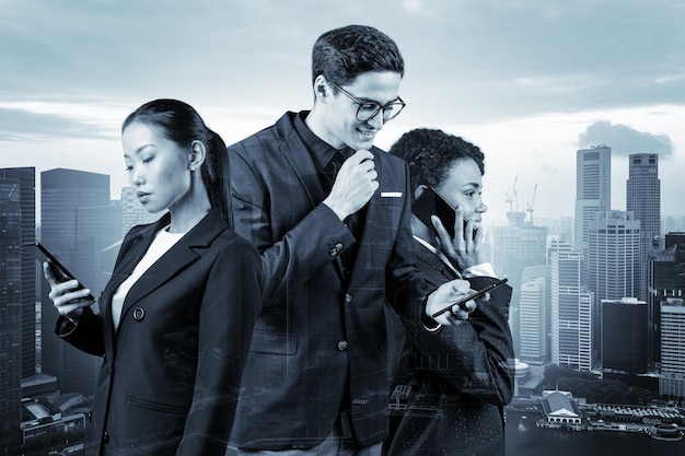 Group of four business colleagues in suits working and dreaming about new career opportunities after MBA graduation Concept of multinational corporate team Singapore on background Double exposure