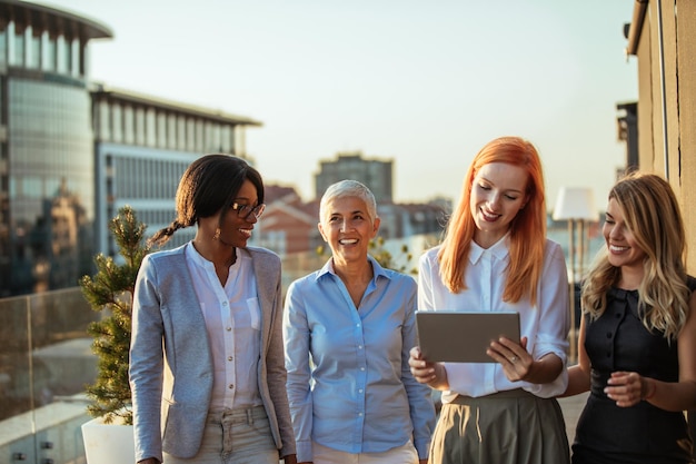 Group of four businesswomen talking outdoors