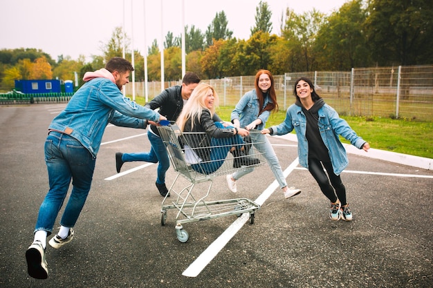 Group of four young diverse friends in jeanse outfit look carefree young and happy on citys streets