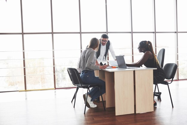 Group of freelancers working in the spacious office with big windows