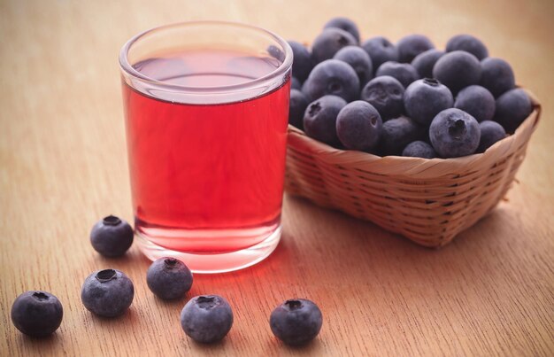 Group of fresh blueberries with juice in a glass