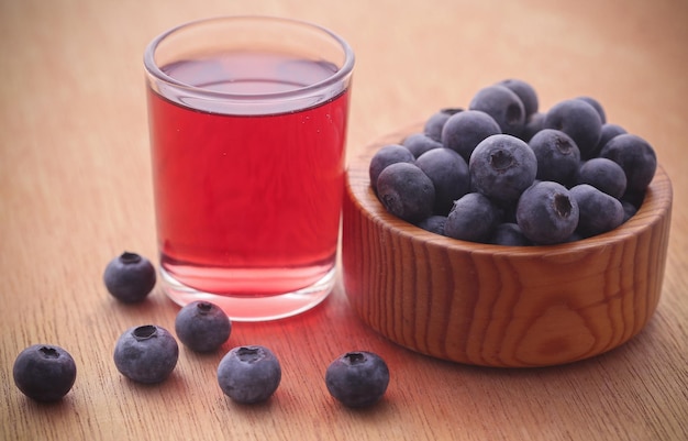 Group of fresh blueberries with juice in a glass