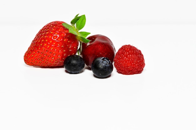 Group of fresh fruits - various colors - on white background.