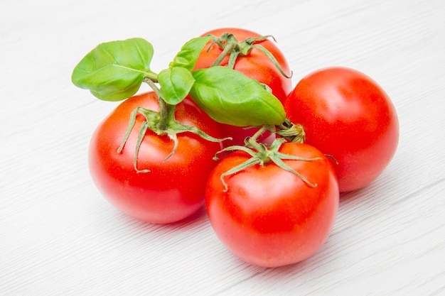 Group of fresh resd tomatoes with basil