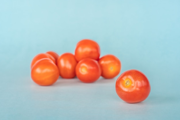 Group of fresh tomato on blue background. Close up stock photo