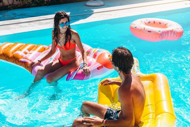 Group of friend play together in the swimming pool