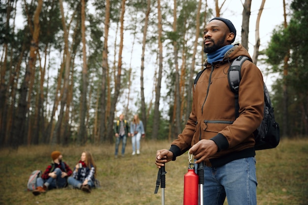 Group of friends on a camping or hiking trip in autumn day