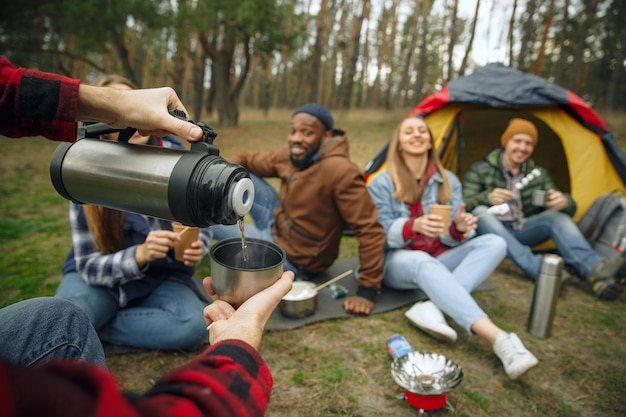 Group of friends on a camping or hiking trip in autumn day