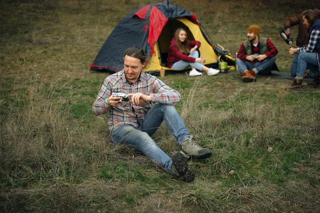 Group of friends on a camping or hiking trip in autumn day