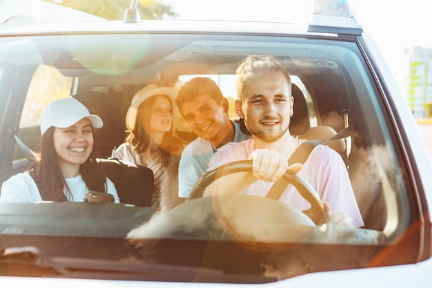 Group of friends in car road trip concept summer vacation