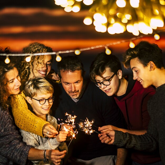 Group of friends celebrate together christmas night or new year eve concept