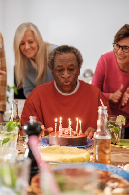 Группа друзей празднует день рождения и дул свечи Концепция счастья связи
