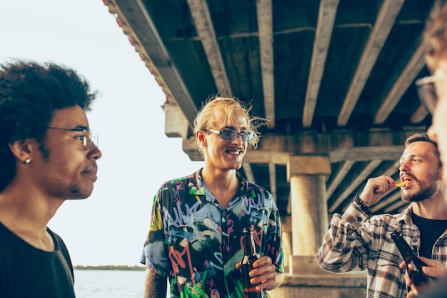 Group of friends celebrating, resting, having fun and party in summer day