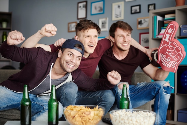 Group of friends cheering at home