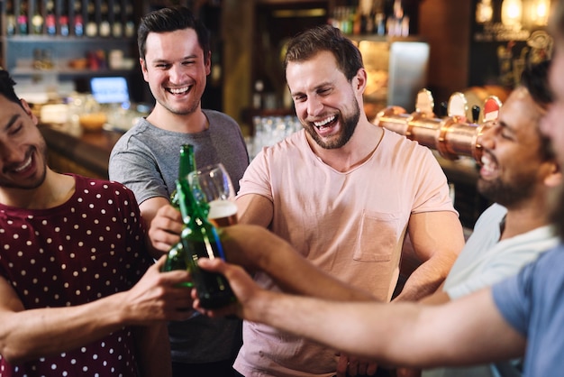 Group of friends chilling with drinks in the pub