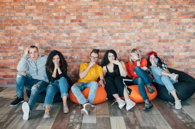  group of friends or colleagues sitting on bean bags. millennial lifestyle