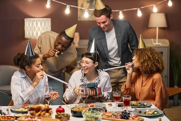 group of friends congratulating cheerful young woman on her birthday