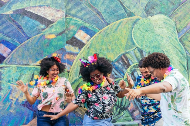 Group of friends dancing in the carnival street