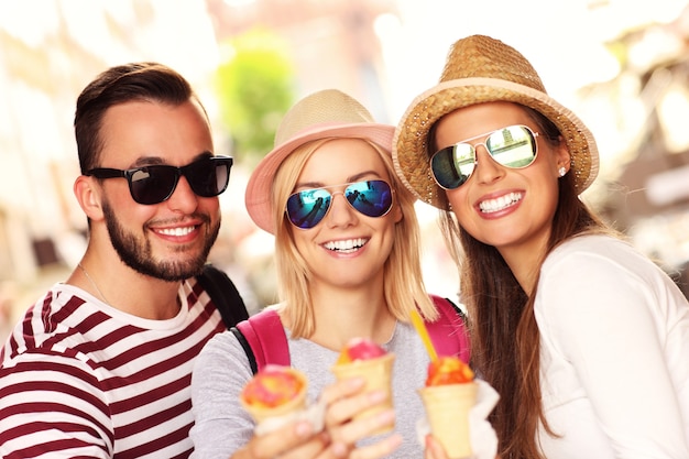 group of friends eating ice-cream in the city