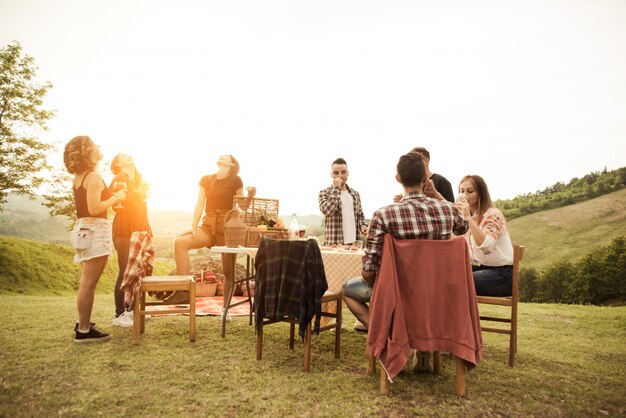 Group of friends eating in the nature