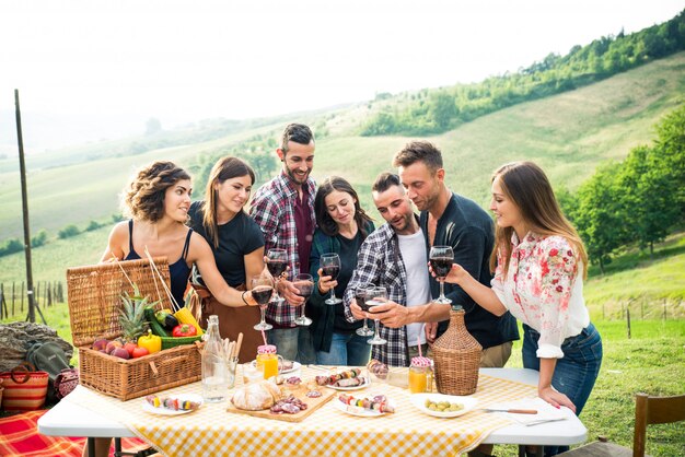 Group of friends eating in the nature